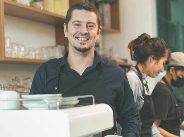 Portrait of a male barista in coffee shop.