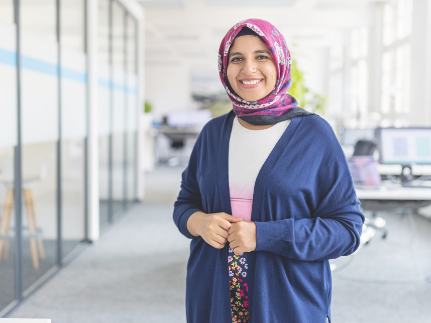 Portrait of happy mid adult Muslim woman standing at startup office