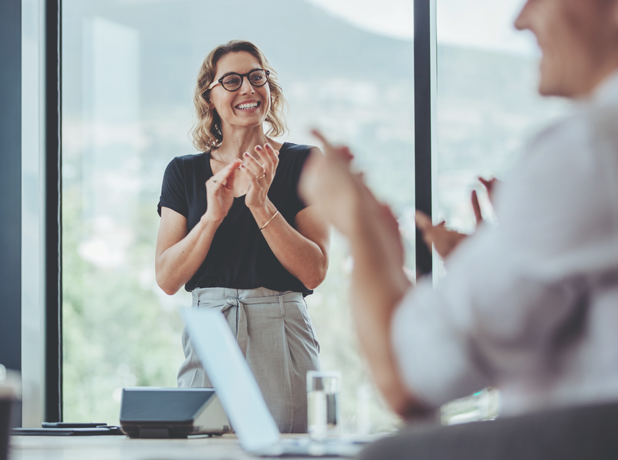 Businesswoman clapping hands after a successful presentation