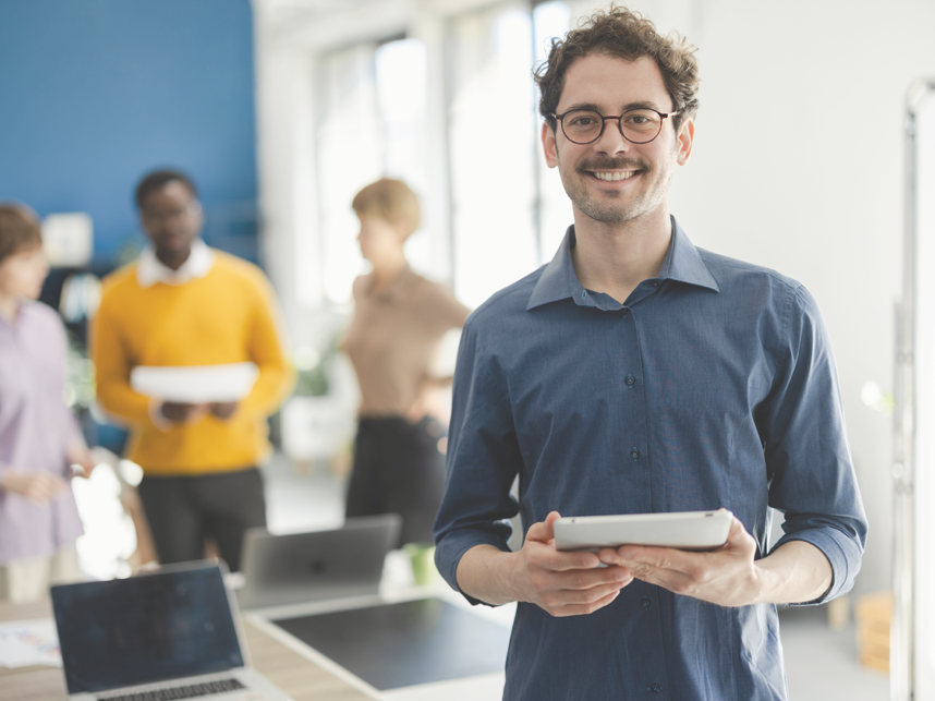 Portrait of a young businessman working at his company as a member of a diverse business team.