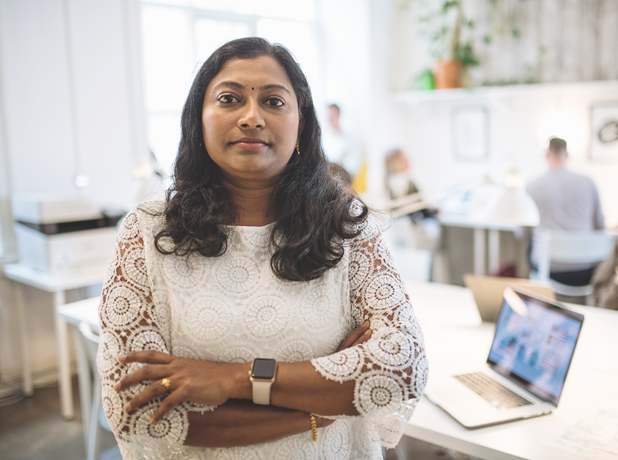 Portrait of mature Indian female employee in office.