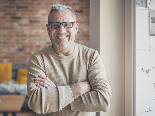 Portrait of an elderly man with a beard, gray hair and glasses