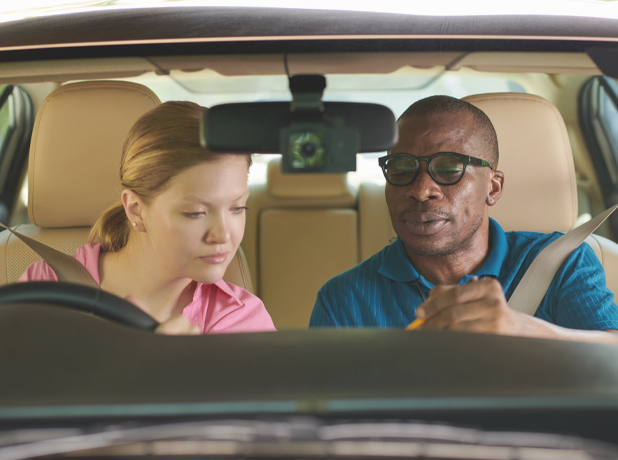 Man taking woman for driving lesson