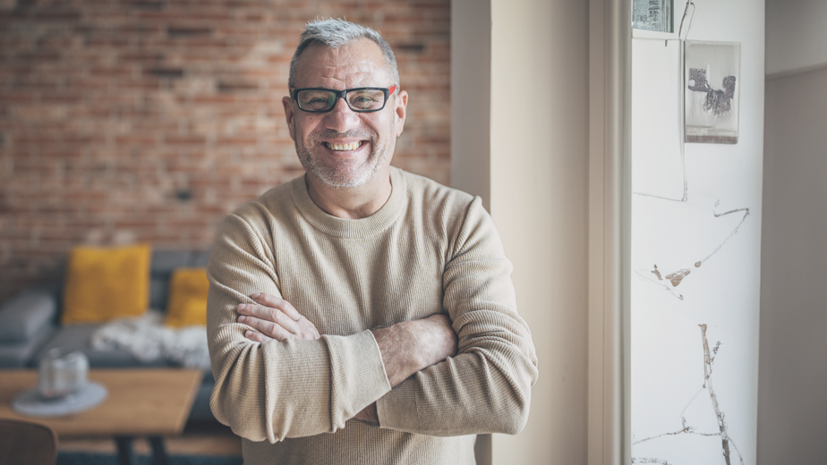 Portrait of an elderly man with a beard, gray hair and glasses