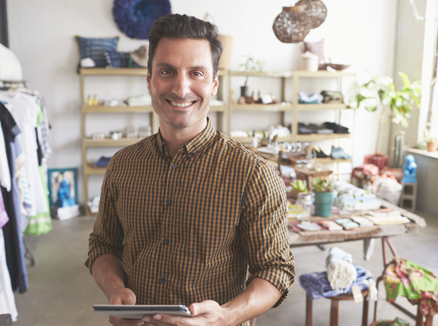 Middle eastern man smiling at camera in retail store